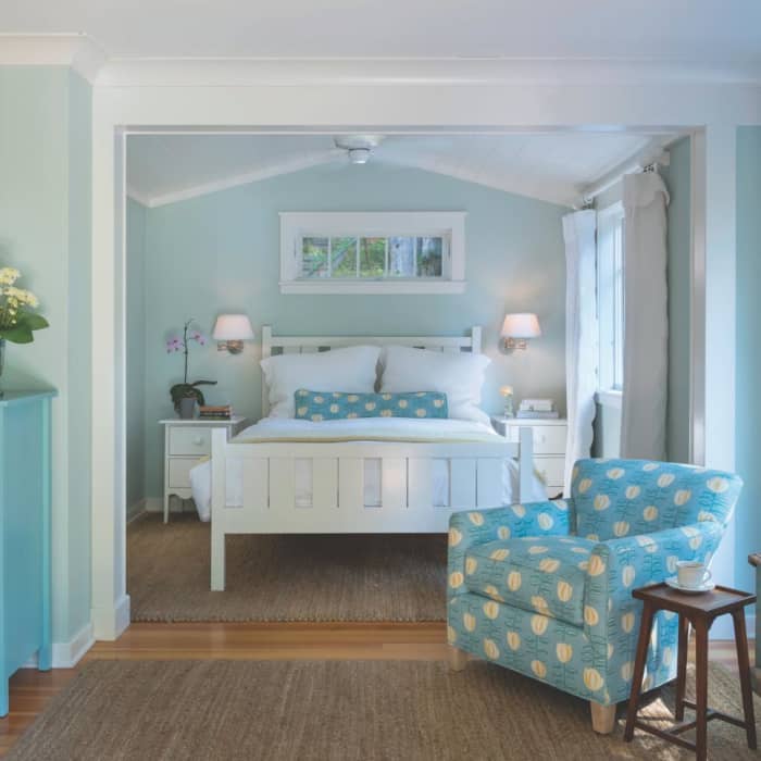 A small armchair wears the same turquoise-and-yellow upholstery and offers a sweet spot to enjoy a cup of coffee each morning.