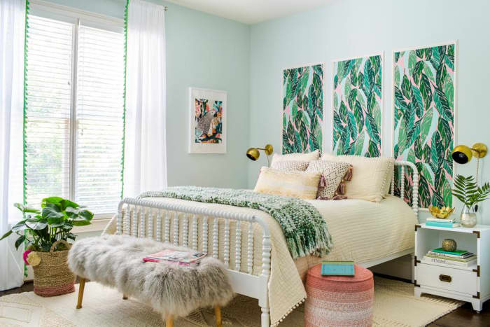 The bohemian theme in the space continues with textured bedding, pom-pom trimmed curtains and a woven jute tote-turned-planter.