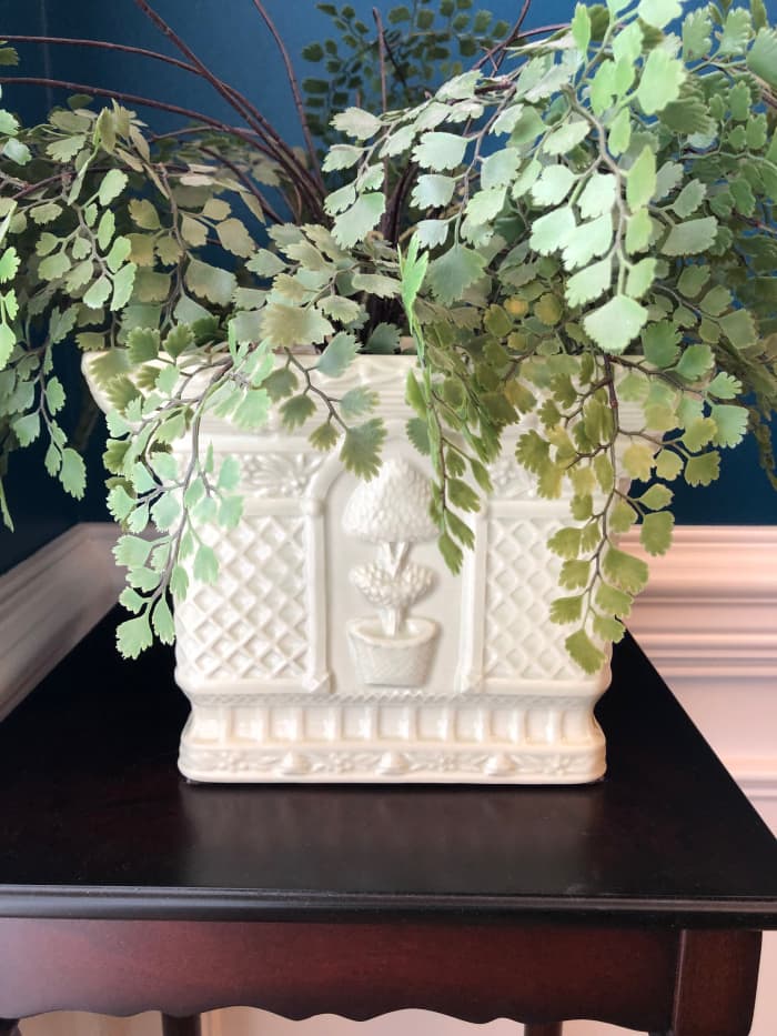 This is my favorite cache pot. it holds this maidenhair fan fern most of the year, but during the holidays, it holds a potted poinsettia or my Christmas fern.