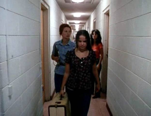 Denny (Janit Baldwin) checks out Chris (Linda Blair) as she's being escorted by Lasko (Allyn Ann McLerie) to her room