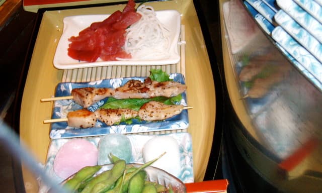 From front to back: Edamame (soybean pods), frozen rice dessert (mochi), a barbecued chicken kebab (yakitori) that I've never tasted, tuna sashimi (another favorite).