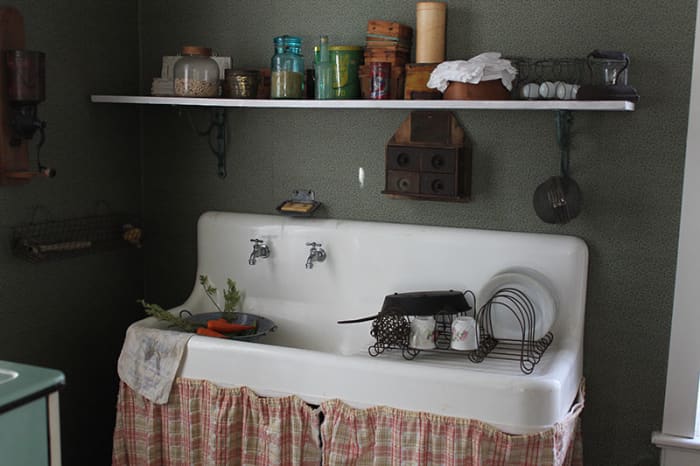 A more modern vintage kitchen with running water. Most older vintage homes would have had a hand pump pitcher pump for water.