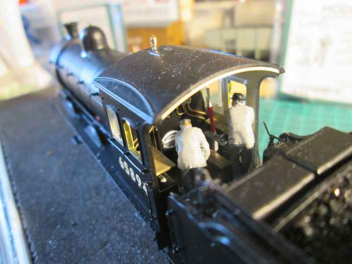 ... And into the cab, over the tender. Features on the model include the 'cradle' for the long fire irons and hinged fall plate. Additions include ModelU crew and lamp on the buffer beam to indicate branch mineral traffic