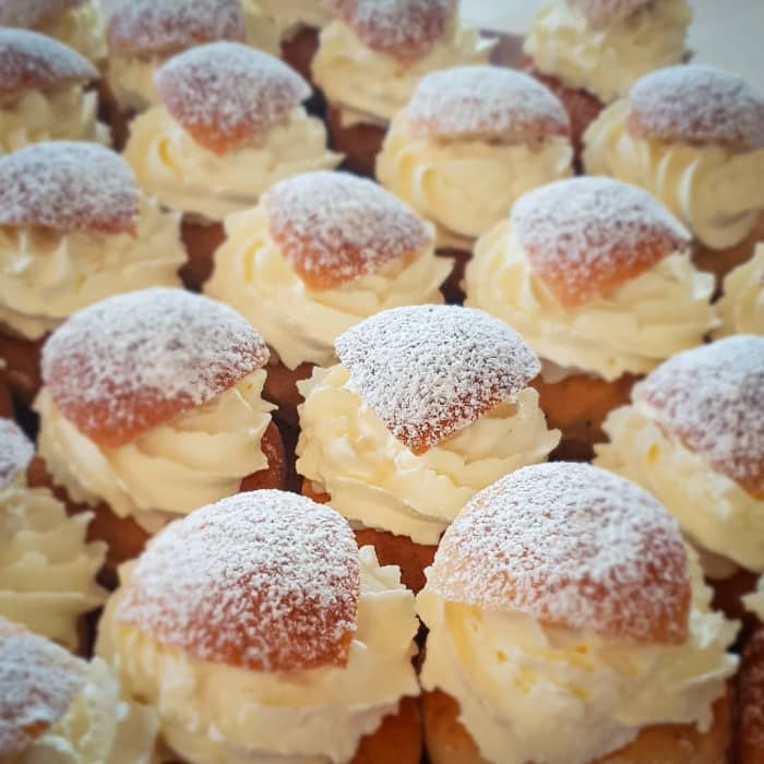 Semlas are buns made from white flour that is a traditional Swedish comfort ‘food’ invented in 1541. A typical semla is a heavy bun dish covered with cream, chocolates, fruits, and topped with hot milk and raisins.