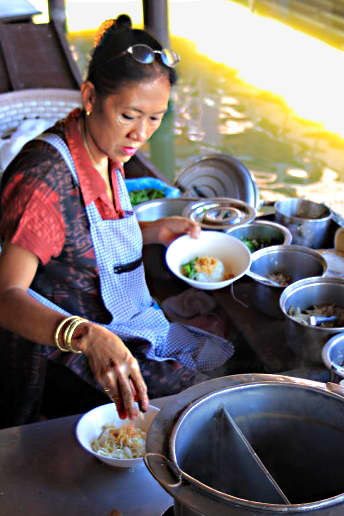 A multitude of pots and pans and bowls. The floating market at the tourist site of Muang Boran has much in common with roadside stalls in the modern city