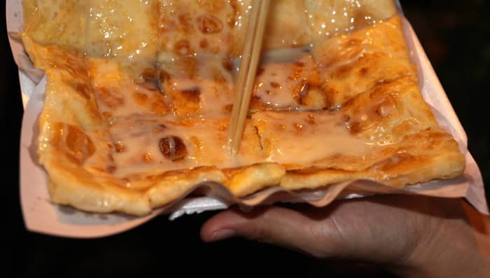 Roti - a take-away flat, pancake-like snack consisting of wheat based dough with banana chunks or banana paste or other fillings