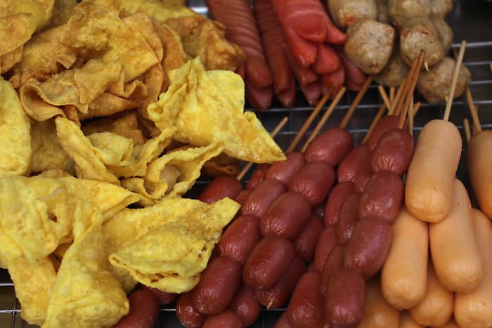 On the left next to the sausage bites are little yellow 'won tons' - triangular dumplings of dough wrapped around pork or fish