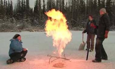 Dr. Katey Anthony flares a methane seep in an Alaskan lake. Dr. Anthony has identified over 100,000 methane sources. Image captured from Youtube video.