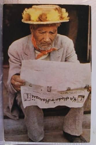 A colorized photo of a Native Hawaiian gentleman reading "Ka Hoku o Hawaii" newspaper, which was a Hawaiian language weekly newspaper published in Hilo, Hawaii. Its founder was Rev. Stephen L. Desha, the kahu at Haili Church in Hilo for 40 years.