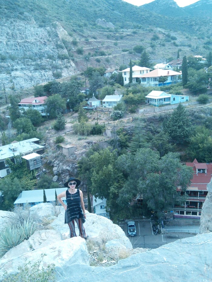 My wife standing at top of Castlerock, Red roof of left portion of Inn at Castlerock appears in lower right of the picture
