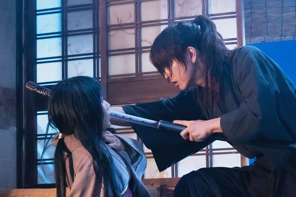 Courtesy of Netflix and Warner Bros. Kenshin nearly kills Tomoe after disturbing his rest after a battle during the Boshin War. Both people were chronologically in their mid-to-late teens.