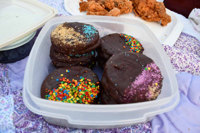 The container is holding moon pies. A moon pie is a cookie sandwich coated in chocolate. The centers have marshmallow filling and jam.
