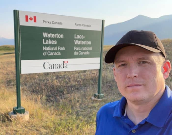 This is the Waterton Lakes National Park entry sign along the highway. Canadian national parks commonly have a sign like this as you enter.