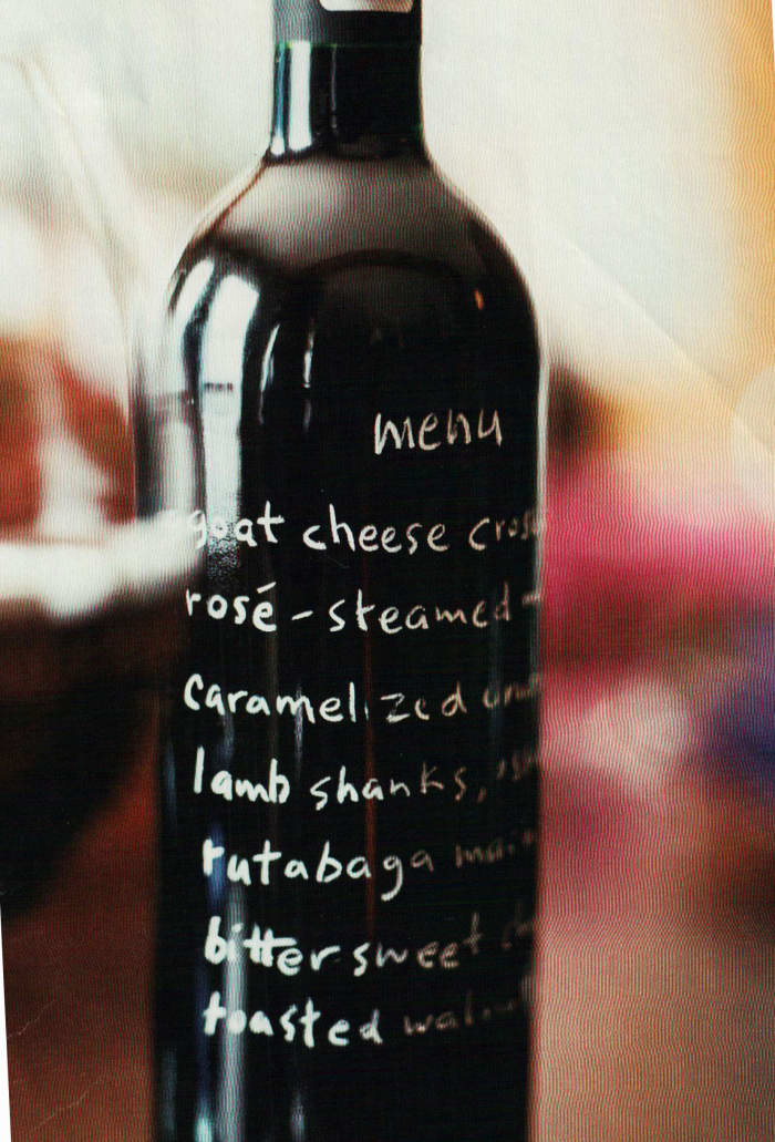 Using an empty bottle as a menu card is fun and easy. Use a white glass marker to let your guests know what you'll be serving.