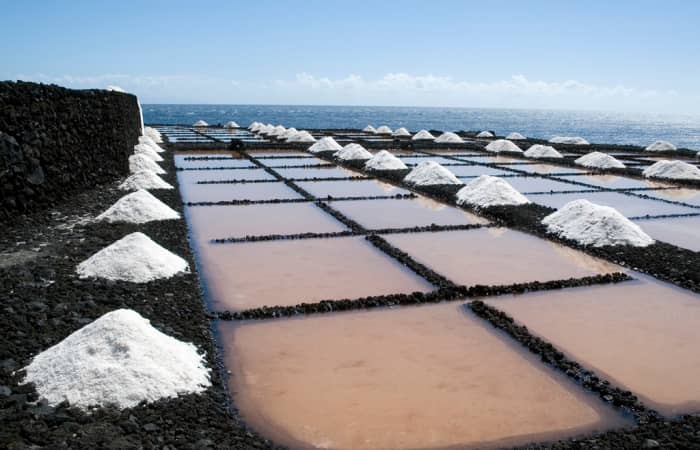 Sea salt paddies, on the far southern tip of La Palma in the town of Fuencaliente, Canary Islands (Isla Canarias). Sea water is pumped up from the ocean below and allowed to evaporate from these shallow pools carved out of the lava rock.