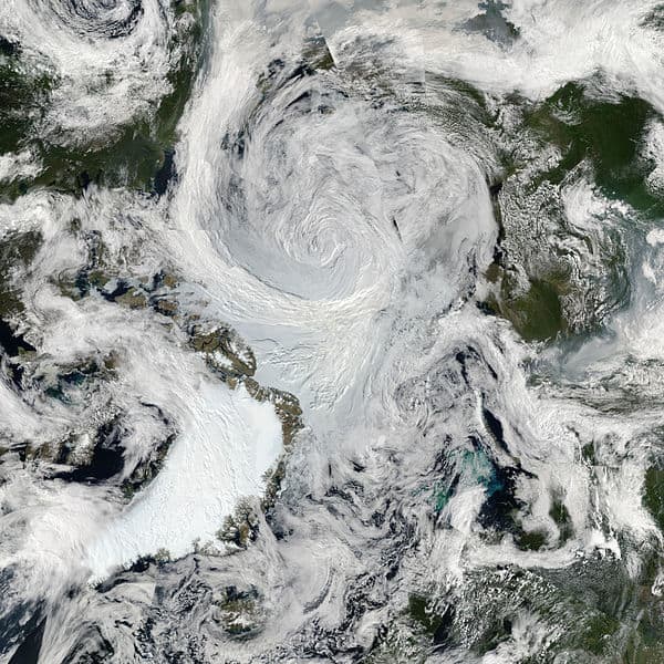 Arctic summer cyclone from orbit, August 6, 2012; Greenland is lower left. Image courtesy NASA & Wikimedia Commons.