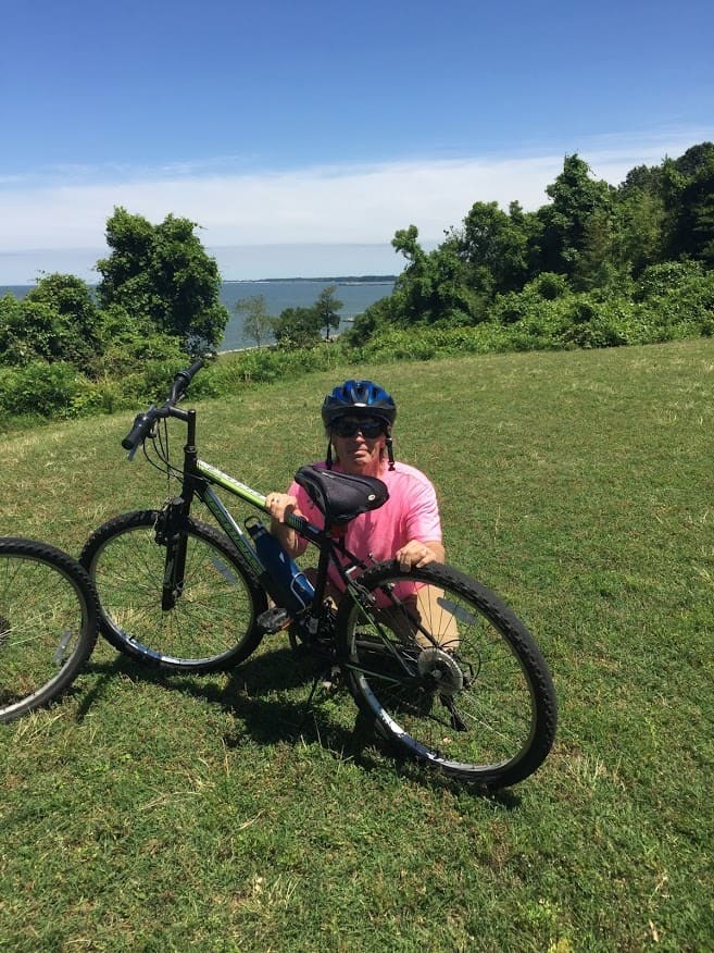 A grassy knoll above Yorktown, VA. This view overlooks the river along which nestles Yorktown Beach during a morning ride.