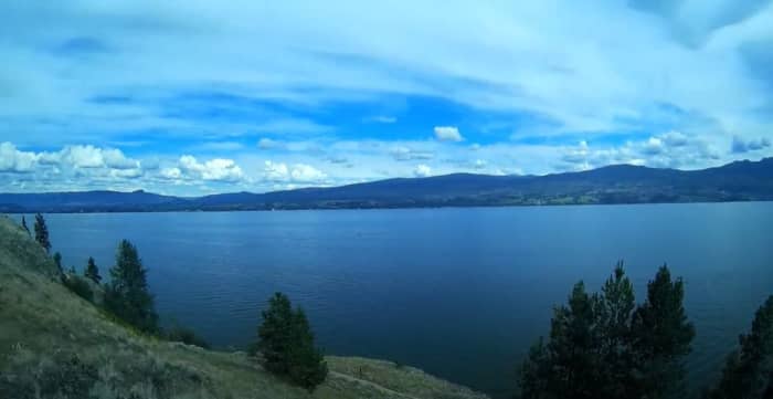 Kalamoir Regional Park in West Kelowna. This shows a viewpoint from a high part of the trail network in the park. The view is toward the east and overlooks Okanagan Lake. This picture is a still taken from a video that was filmed June 29th, 2020.