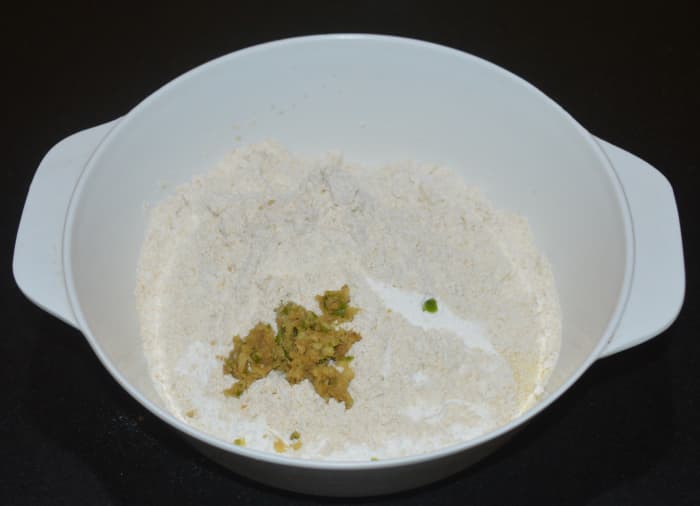 Step one: Add wheat flour, rice flour, semolina, and ginger-green chili-cumin paste to a mixing bowl.