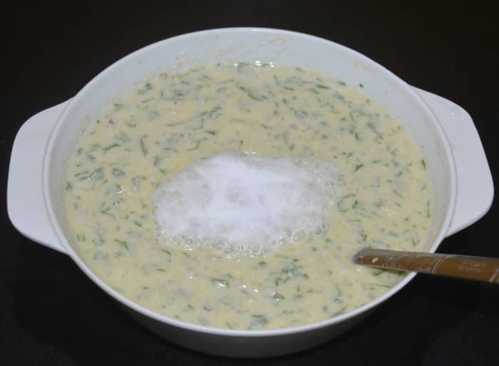 Step three: Add Eno fruit salt or baking soda to the batter. Gently mix it. The batter should increase in volume. The batter should be neither too thick nor too thin. Adjust the consistency by mixing water into the batter.