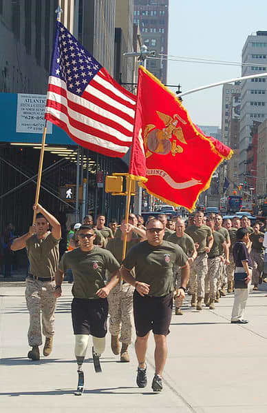 Gunnery Sgt. Angel Barcenas (with Sgt. Justin G. Brown) leads Marines, firemen, and policemen across Manhattan in 2010. His legs were amputated after injuries in Iraq in 2009.