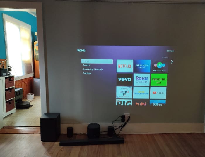 During a sunny day with the curtains closed, the projector's output is watchable but noticeably washed out
