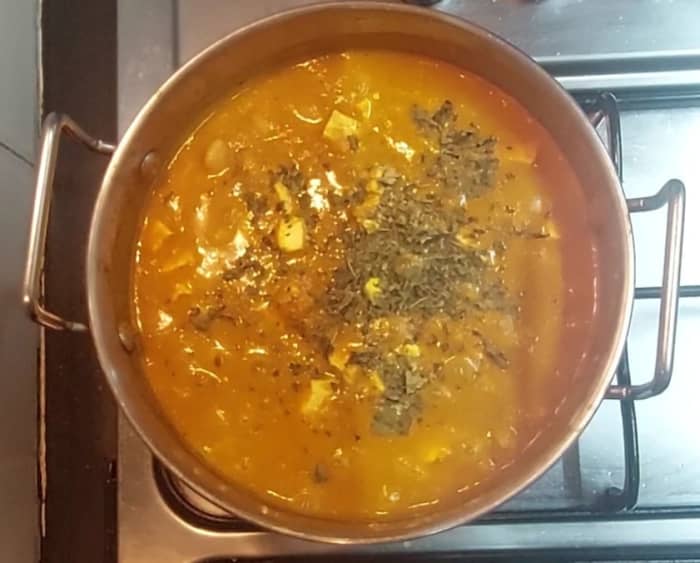 Mix well without breaking the paneer. Close the lid and cook for 3 minutes. Add water if required to adjust the consistency. Add 1 teaspoon crushed kasuri methi, mix and switch off the flame.