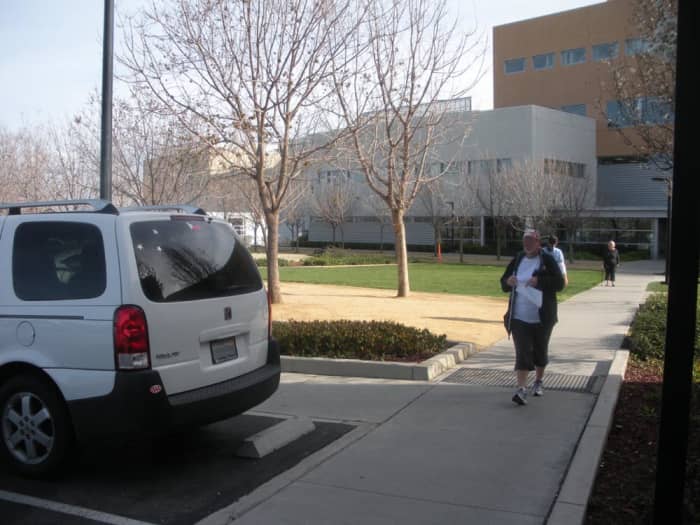 This is taken at our local Kaiser medical center. Note the handicapped-access spaces begin to the left of the white car, while the spaces at 90 degrees to the front of that car are not designated as handicapped