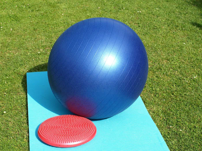 A balance ball is a large plastic inflatable ball used for sitting upon and for exercise.