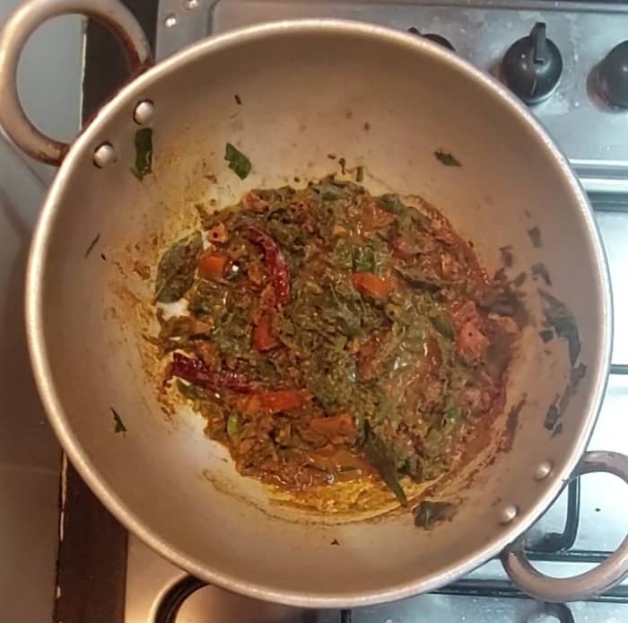 Add 1/4 cup of water, mix. Close the lid and cook for 2 minutes till tomatoes and palak cooked well.