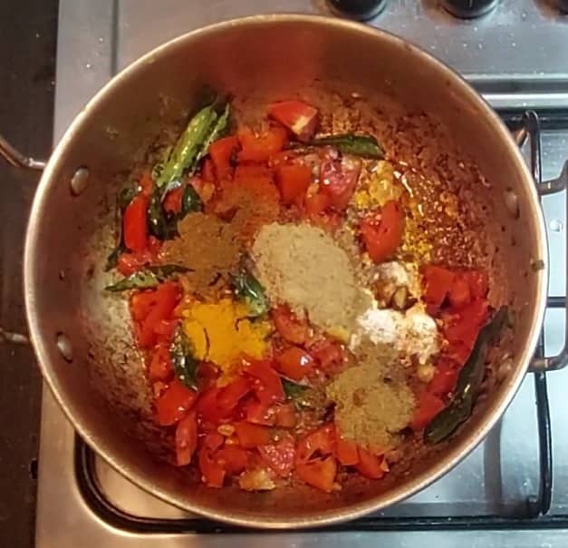 Add 1 cup chopped tomatoes, saute till tomato shrinks. Add 1/2 teaspoon turmeric powder, 1 teaspoon cumin powder, 1/2 teaspoon red chili powder, 1 teaspoon coriander powder, 1/2 teaspoon garam masala powder, mix and combine well.