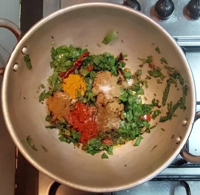 Add 1/2 teaspoon turmeric powder, 1 teaspoon red chili powder, 1 teaspoon coriander powder, 1/2 teaspoon garam masala powder, salt, mix everything properly.