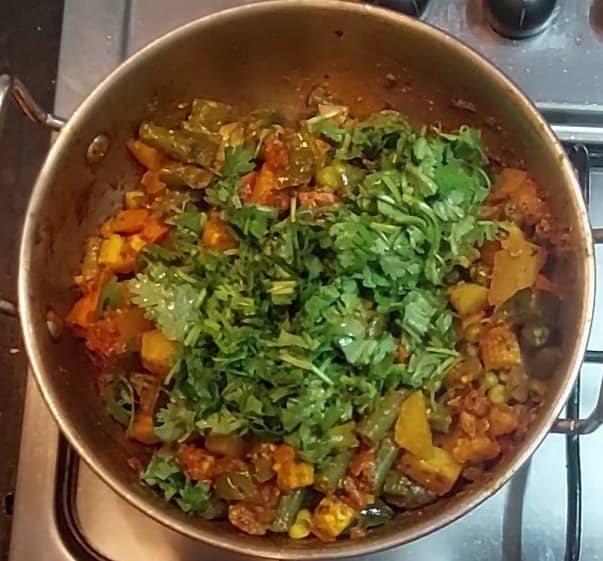 Once water dried completely and vegetables are cooked, add 1/2 cup chopped coriander leaves. Mix and switch off the flame.