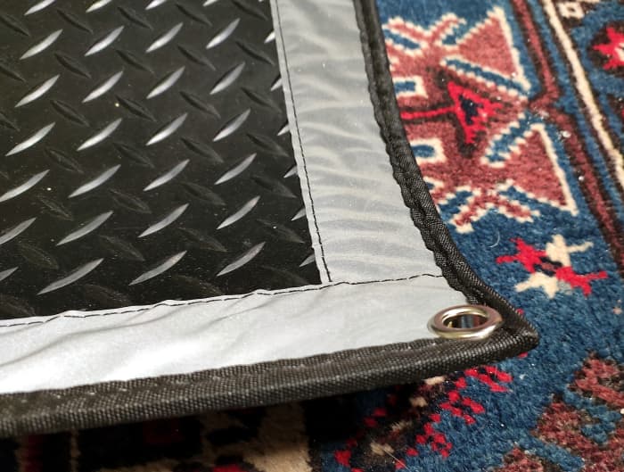 A grommet on each corner of the mat allows it to be pinned to the ground with stakes