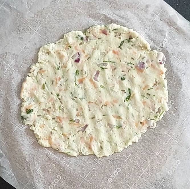 Take a sheet of butter paper, grease 1 teaspoon oil, place roundel on the butter paper and pat roti as thin as possible.