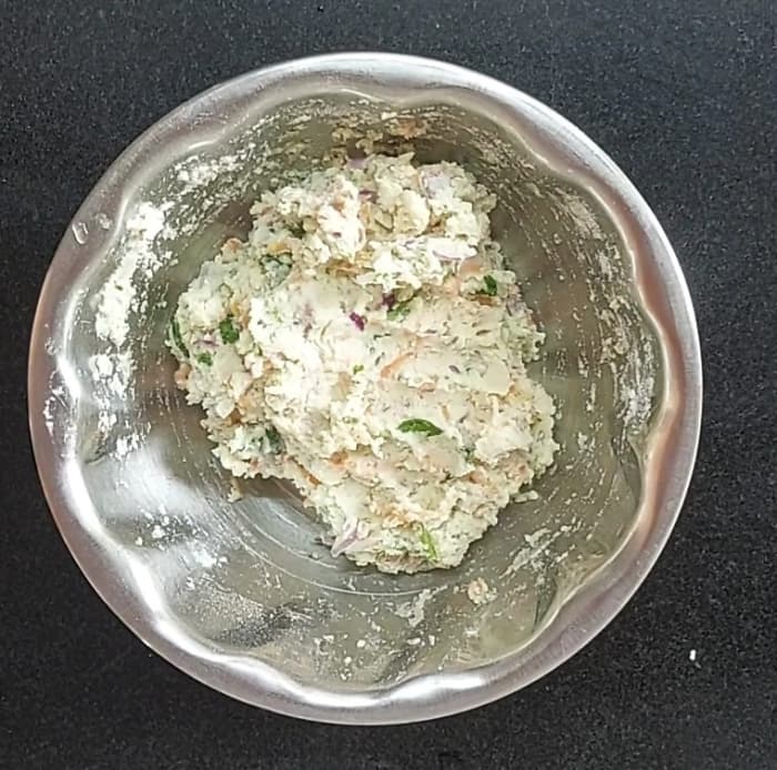 Once it is hot enough to handle with hand, mix well and make dough. The dough should be softer than roti or chapati dough. Add 1 teaspoon of oil, mix well.