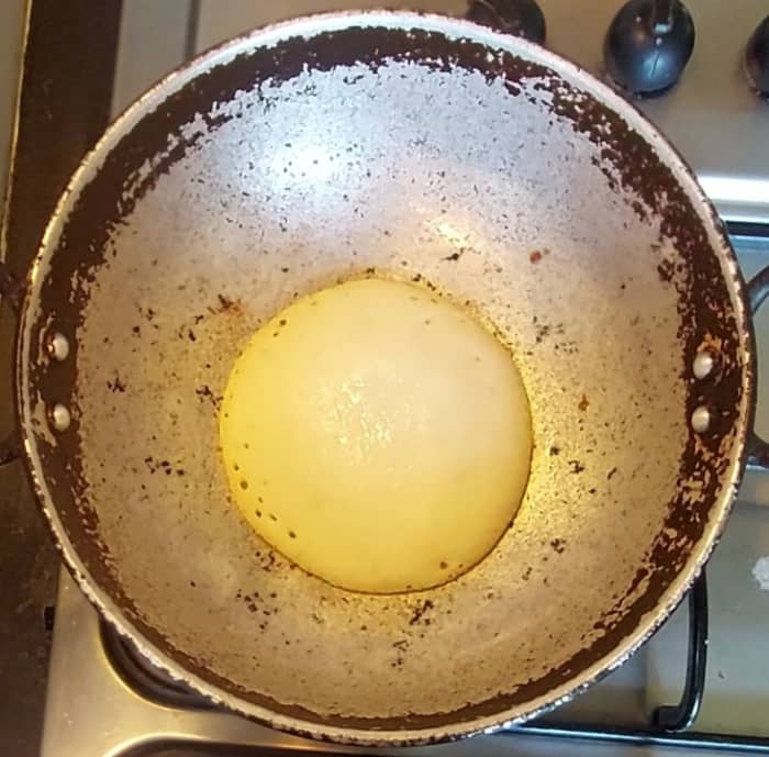 Heat pan (banale), add 1 teaspoon oil, add a ladle full of batter, do not spread, add few drops of oil to the sides, close the lid and cook in low flame for 1-2 minutes or dosa turns golden brown.
