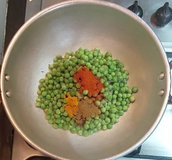 Add 1/2 teaspoon turmeric powder, 1 teaspoon red chili powder, 1/2 teaspoon garam masala powder, mix and combine well.
