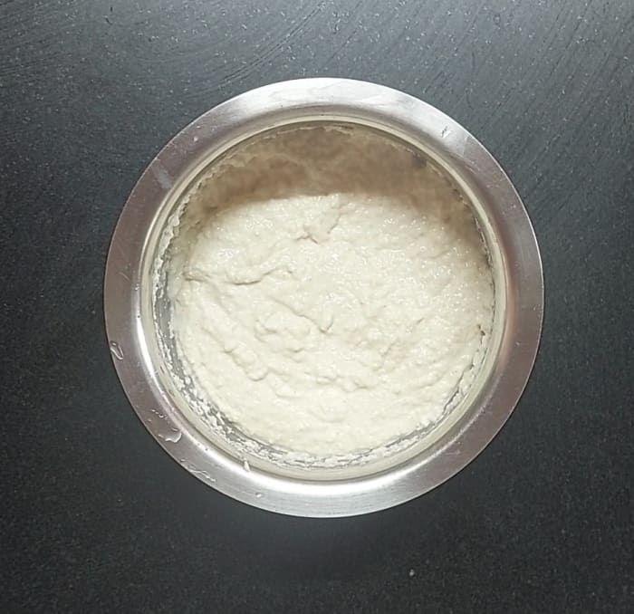 Mix well without forming lumps. Add salt, mix and keep aside for 5 minutes. After 5 minutes, batter thickens as rava absorbs the water. Add water as required, mix well to form thick but pouring consistency batter.