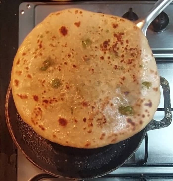 Fry on both sides till brown spots appears. Once done transfer to a plate. Repeat the same procedure and make remaining parathas.
