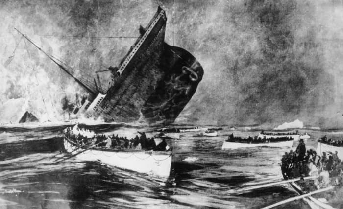 14th April 1912: Survivors watch from the lifeboats as the ill-fated White Star liner, the 'Titanic', plunges beneath the waves.