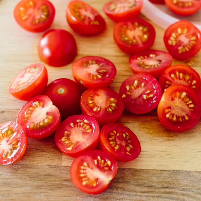 Cherry-tomatoes they are perfect for this dish, There a small tomato that has a shape like Bing cherries and they are juicy and have very good flavor and if you sauté them, it brings out the total sweetness that takes then up another notch.