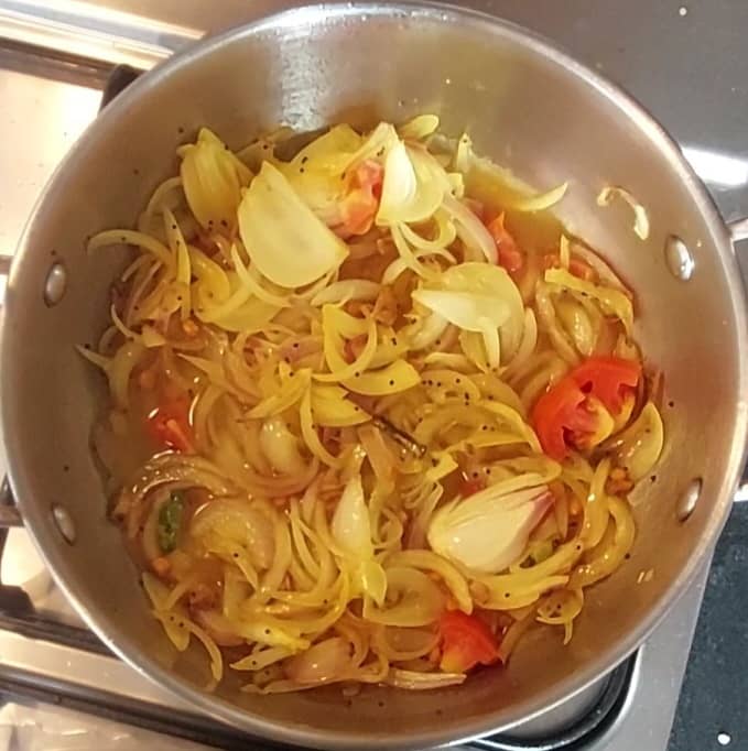 Add 1 optional chopped tomato, and give a quick mix. Add 1/2 cup of water and mix. Close the lid and cook over medium flame for 5 minutes.