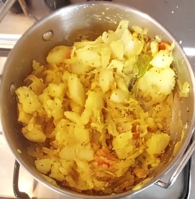 After the onions are cooked well, add the cubed potatoes and salt to taste. Mix well (break big chunks of potatoes if any).