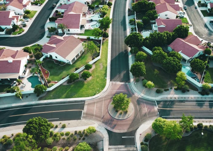 This neighborhood uses a mix of traffic calming methods (roundabout) as well as sidewalks that are both attached and detached from the street. While not perfectly walkable, this newer development has at least considered pedestrian routes.