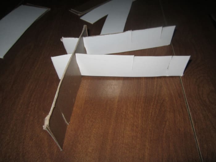 Piece compartments together by sliding the slits together. Make sure all of the cuts on your slips line up with the rest in the row or you may get confused.