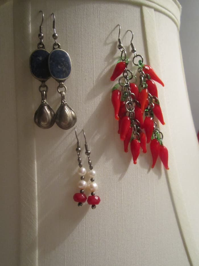 Lamp Jewelry Stand - Dress up a boring lamp with your jewelry or convert an old lamp into a jewelry stand by simply hanging your pieces off of it.