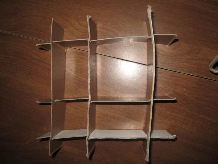 Continue until your compartments are complete and slide into your box. I completely freestyled the cutting for this and as you can see it results in wobbly compartments. For crisp clean compartments make exact cuts and use a ruler.