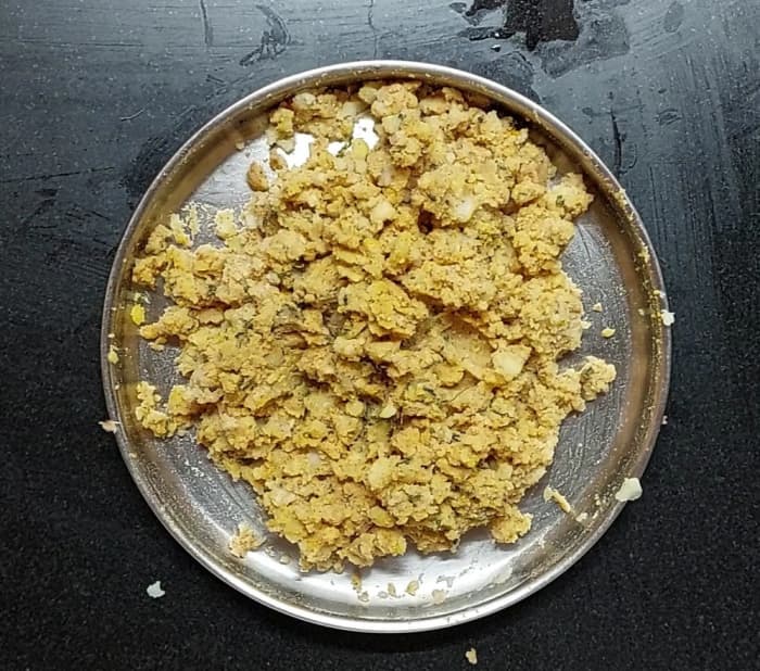 Add 1/2 teaspoon turmeric powder. Adjust salt if required. Mix well. Check the smoothness of the potatoes and mash the chunks if any.