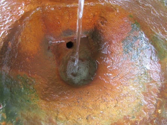 Mineral spring basin The water from the mineral springs is high in iron which creates a distinctive orange-gold mineral buildup.
